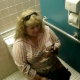 A big, fat girl is video recorded sitting on the toilet chattering about her cell phone. We are not sure if she is peeing, pooping, or both.